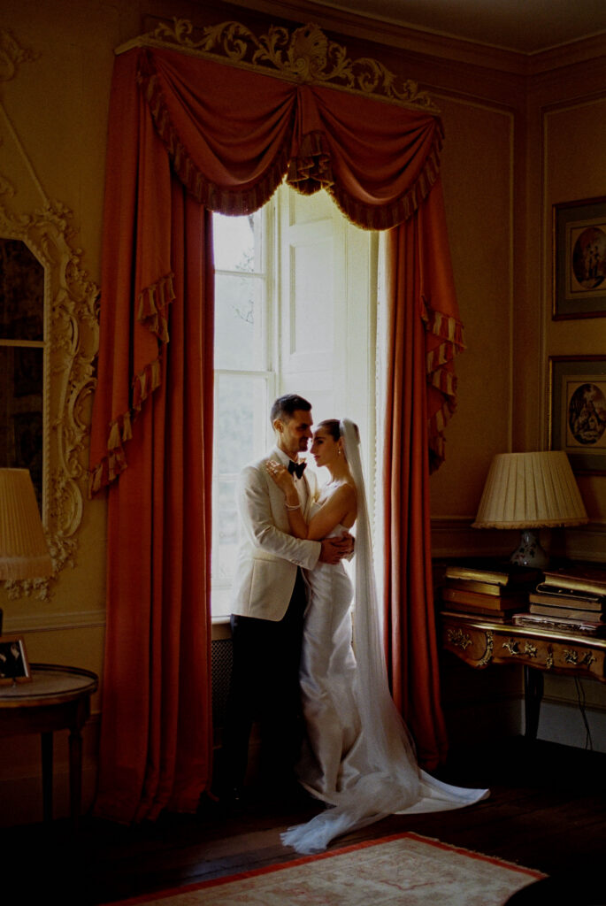 Bride and groom having a quiet moment during their first look. Photographed on 35mm film